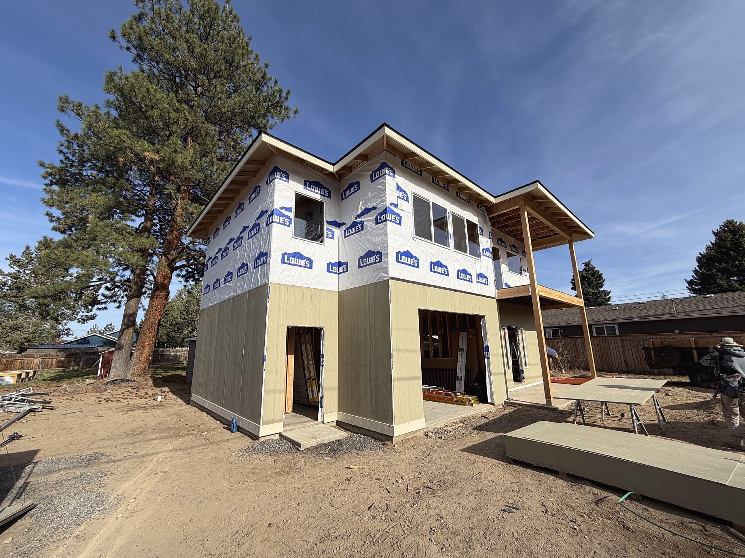 Martinsen Construction, two-story residential exterior during siding installation, Central Oregon